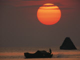 Kabang Silhouetted against the Sea at Sunset Photographic Print by Nicolas Reynard
