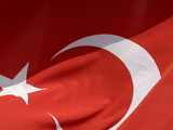 Close-up of the Flag of Turkey with a White Star and Moon on Red Fabric Photographic Print