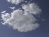 A Deep Blue Sky with Bright Fluffy White Clouds Photographic Print