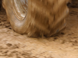 Tire Churning Through Mud Lámina fotográfica