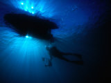 Diver Underneath Boat with Sunlight, Leigh, New Zealand Photographic Print by Jenny & Tony Enderby
