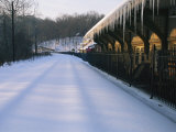 A Pristine Blanket of Snow Covers an Empty Train Station Photographic Print by Nick Caloyianis