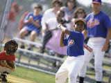 Boy Swinging a Baseball Bat on a Field Photographic Print