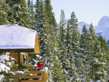 Skiers on Balcony of Ski Lodge Prepare for Skiing Photographic Print by Mark Cosslett