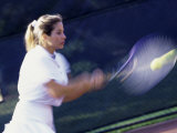 Side Profile of a Young Woman Playing Tennis Photographic Print
