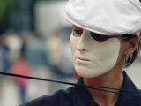 A Street Performer Wears a Mask Concealing Her Expression Photographic Print by Jim Webb