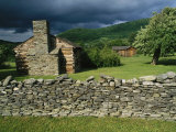 Storm Clouds Form Above Log Buildings on the Site of French Azilum Photographic Print by Raymond Gehman