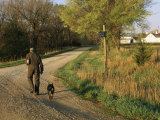 A Man and Dog Walk Along the Road Near Historic Stevens Creek Farm Photographic Print by Joel Sartore