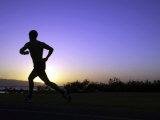 Silhouette of a Man Running Photographic Print