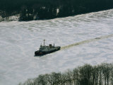 A U.S. Coast Guard Boat Breaks its Way Through the Icy River Photographic Print by Heather Perry