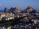 City Buildings and Limestone Karst Peaks in the Li River, Guilin, Guangxi, China Photographic Print by Richard I'Anson