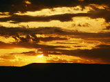 Clouds are Colored Shades of Orange by the Low Sun over 70 Mile Butte Photographic Print by Raymond Gehman