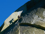 A Rock Climber Scales the Flat Rock Surface of a Cliff Near Needles, California Photographic Print by Barry Tessman