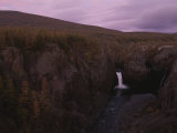 A Waterfall Spills into the Pristine Waters of the Lake Below Photographic Print by Randy Olson