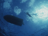 Underwater View of Swimmers and a Boat at the Surface of the Ocean Photographic Print by Randy Olson