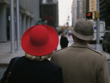 Rear View of Two People Wearing Hats Stopped at a Crosswalk Photographie par Raul Touzon