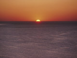 A Brillant Orange Sun Dips Behind the Mediterranean Sea Photographic Print by James L. Stanfield