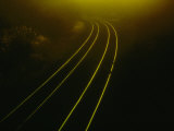Train Tracks Disappearing into the Distance Around a Curve Photographic Print by Todd Gipstein