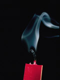 Red Candle with Smoke Curling up from the Wick after Being Blown Out Photographic Print by Brian Gordon Green