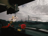 View from Inside a Car of Smokestacks Spewing Pollution into the Air Photographic Print by Randy Olson