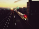 A Trans-Canada Railway Train Rushes Down the Tracks at Dusk Photographic Print by Paul Chesley