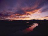 A Gorgeous Purple and Gold Sunset Tints Windswept Clouds and the Sweetwater River Photographie par Lowell Georgia