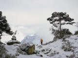 A Member of the Mount Everest Expedition Stands Near a Stone Pagoda Photographie par Barry Bishop