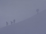 Climbers are Barely Visible on the Cloudy Mountain Side Photographie par Paul Chesley