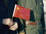 A Pair of Hands Holds the National Flag of China Photographie par Paul Chesley