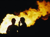 Natural Gas Workers Silhouetted by Burning Dross Photographic Print by George F. Mobley
