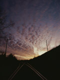 Clouds at Twilight Create Purple and Pink Streaks Across the Sky Photographic Print by Sam Kittner
