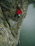 A Man Climbs Above a Canoe in the River Fotografisk trykk av Dugald Bremner