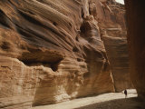 A Hiker is Dwarfed by the Sandstone Walls of a Utah Canyon Fotografisk trykk av Dugald Bremner
