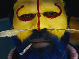 A Huli Warrior in Full Bird-Of-Paradise Ragalia Glowers During a Festival Photographic Print by Jodi Cobb