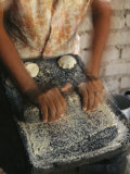 A Cora Woman Grinds Corn for Tortillas Photographic Print by Maria Stenzel