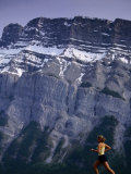 Woman Running in Front of Mountain, Banff, Canada Photographic Print by Woods Wheatcroft
