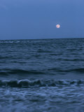 A Twilight Shot of Waves Coming into Shore with the Moon in the Background Photographic Print by Ira Block
