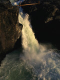 Man Crosses a Log Bridge above a Waterfall on the Yagtali River Photographic Print by Randy Olson
