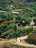 Mountain Bikers Ride out from Batopillas, Satevo Mission Behind Photographic Print by Skip Brown