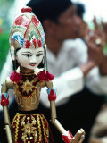 Traditional Puppet with Vendor in Background, Jakarta, Indonesia Photographic Print by Nicholas Pavloff