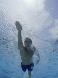 Low Angle View of a Young Man Swimming Underwater Photographic Print