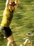 Young Man Sitting on a Bicycle with His Arms Raised Photographic Print