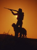 Silhouetted Hunter with Dog Photographic Print