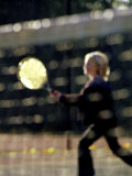 Blurry Image of a Girl Playing Tennis Photographic Print