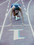 High Angle View of a Young Woman at The Starting Position of a Running Track Lámina fotográfica