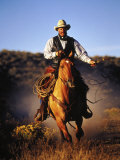 Cowboy on Running Horse with Whip Photographic Print by Inga Spence