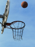 Low Angle View of a Basketball Bouncing Off The Hoop Photographic Print
