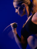 Side Profile of a Young Woman Exercising in a Health Club Photographic Print