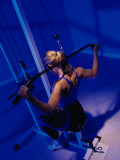 Rear View of a Young Woman Exercising in a Health Club Photographic Print