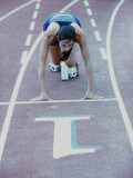 High Angle View of a Young Woman at The Starting Position of a Running Track Lámina fotográfica